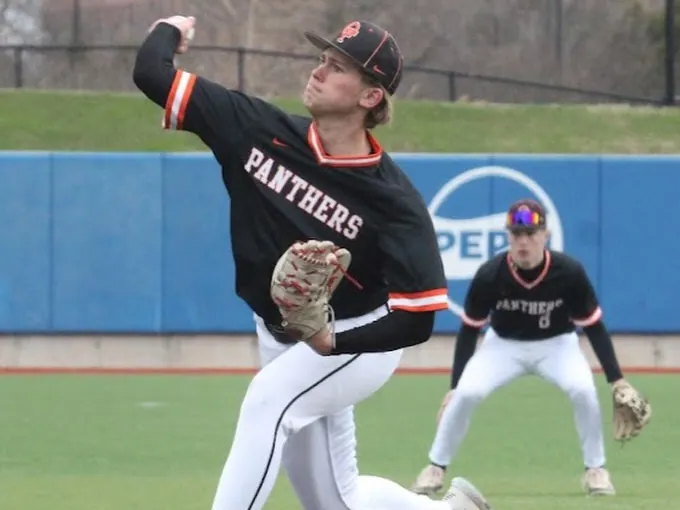 Carter delivering a pitch from the mound in a black Panthers jersey
