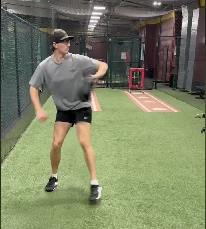 Eddie throwing in an indoor training cage