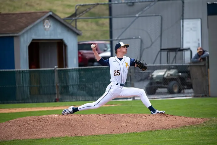 Evan pitching from the stretch in a white uniform