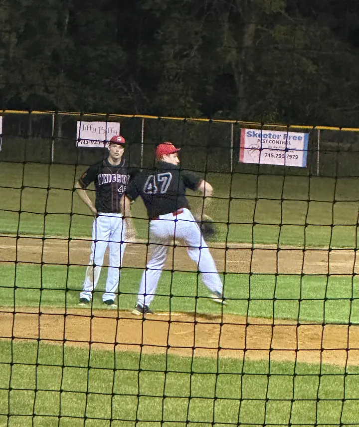 Ryan on the field behind the backstop netting