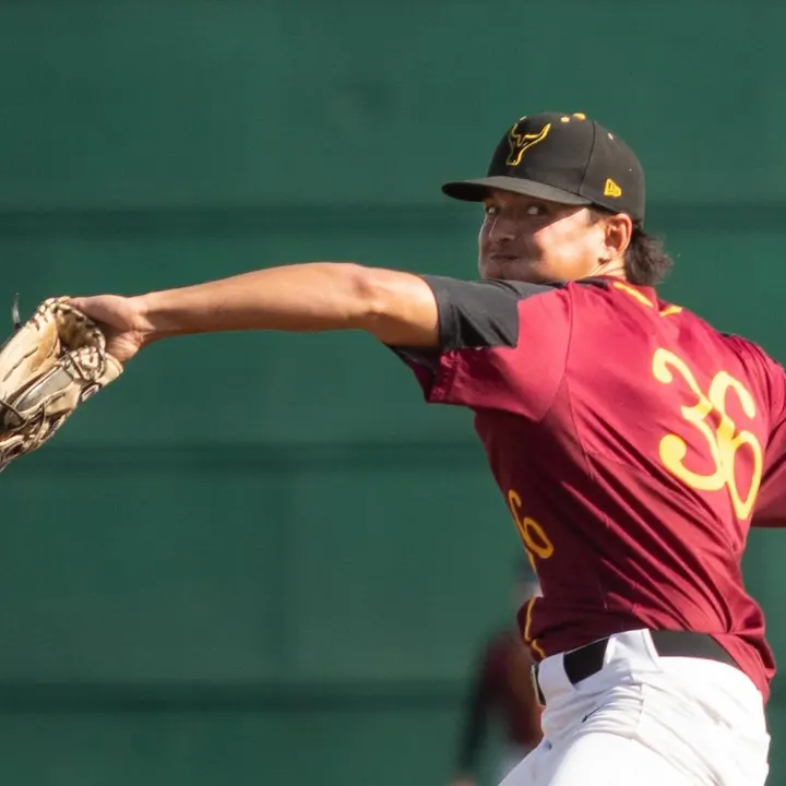 Zaid releasing a pitch in a maroon jersey